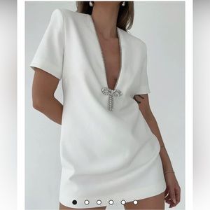 White rumored dress with crystal trim and bow